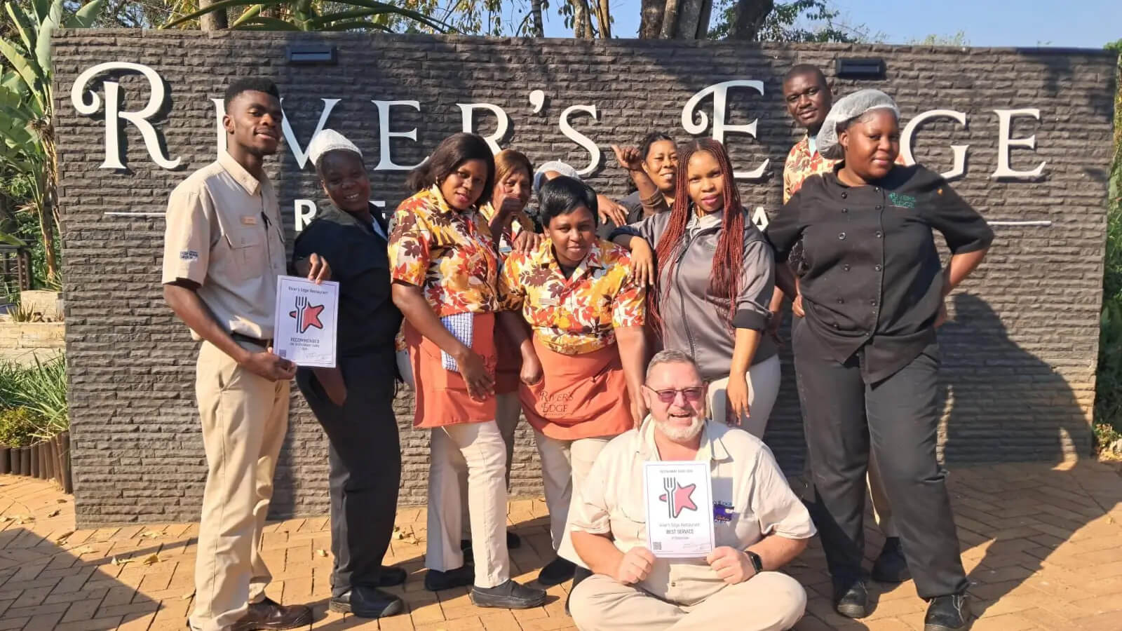 The Waffling Whale Café staff celebrating their recognition by the Restaurant Guru